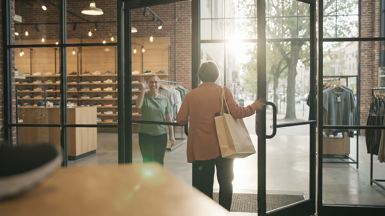 A customer leaving the store with a bag